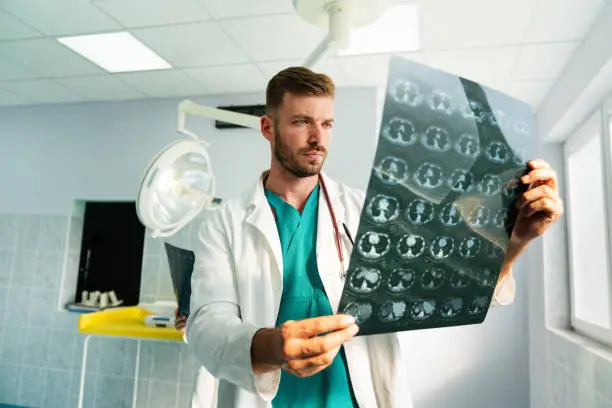 Photo of Radiologist, doctor examining x-ray images of patient for diagnosis