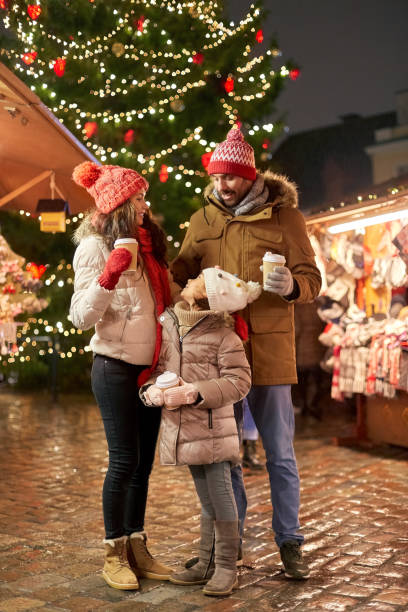 istock family with takeaway drinks at christmas market 1367112111