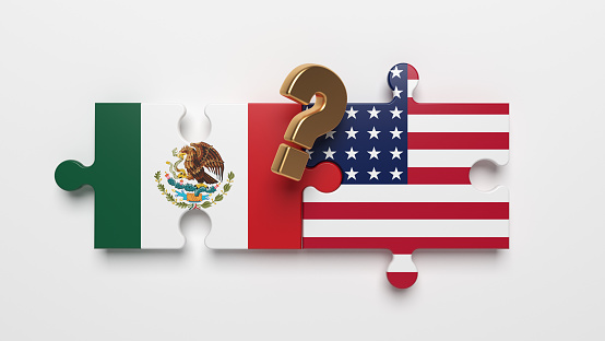 Gold-colored question marks symbol and American and Mexican flag on the puzzle. International relation concept.  Horizontal composition with copy space. Isolated with clipping path.