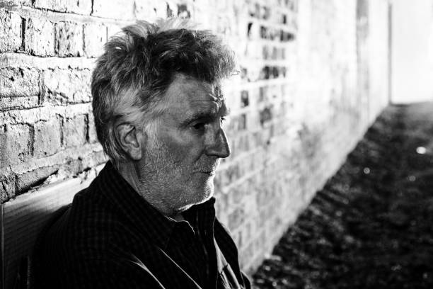 istock Senior homeless man sitting in dark tunnel 1367113379