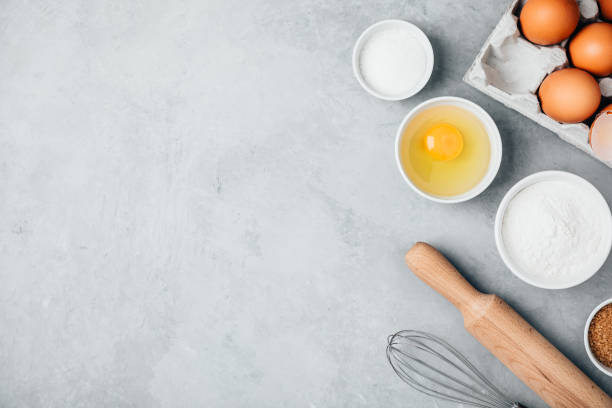 istock Baking ingredients. Flour, eggs, sugar, roller pin and whisk on the kitchen table. 1367114896