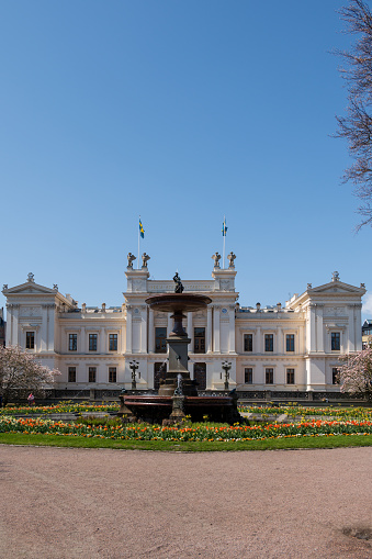 The fountain and the facade of the historic university building in Lund Sweden during spring