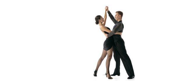 istock Flyer with young couple of dancers dancing Argentine tango isolated on white studio background. Artists in black stage costumes 1367116464