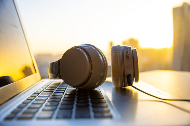 Headphones with laptop on wooden table