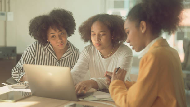 istock Group of women studying e-learning about taxes 1367117680