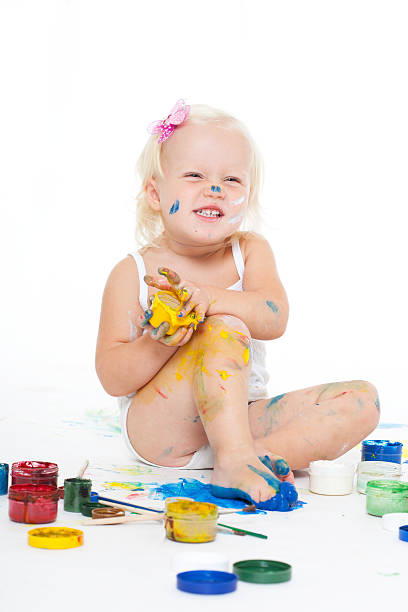 istock little girl bedaubed with bright colors 136711835