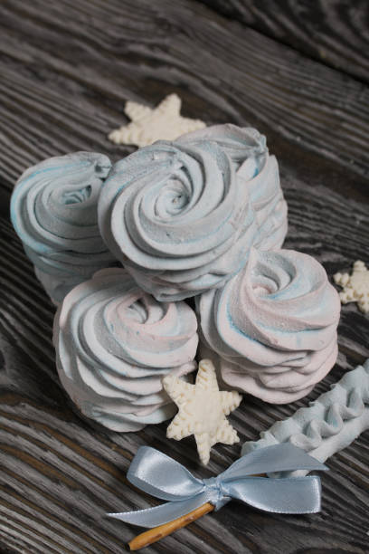 istock Marshmallow blue and pink. zephyr on a stick. Decorated with mastic snowflakes. 1367119011