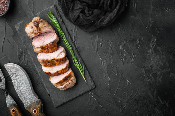 istock Grilled duck meat, on stone serving board, on black stone background, top view flat lay, with copyspace  and space for text 1367119514