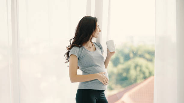 istock Pregnant mother happy drinking milk 1367122220
