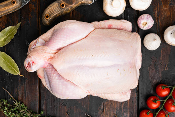 istock Whole chicken, on old dark  wooden table background, top view flat lay 1367122565