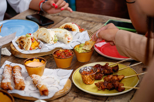 istock Dipping tortilla chips into sauce, Mexican food snacks on restaurant table 1367123239