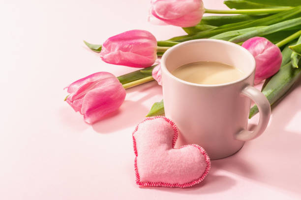 istock Romantic flat lay composition with a cup of coffee, soft felt hearts, and fresh tulips 1367123265