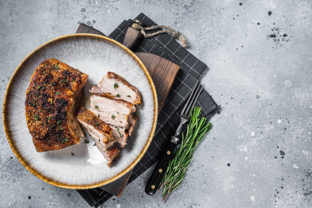 istock Filipino marinated pork belly with crust in a plate. Gray background. Top view. Copy space 1367126986