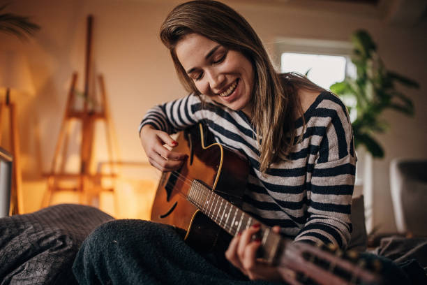 istock Woman playing a guitar 1367127366