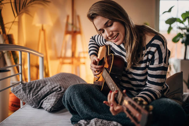 istock Woman playing a guitar 1367127386