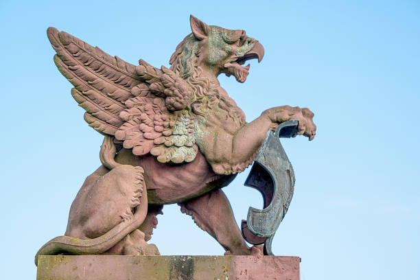 Scary ancient griffin from Moltke Bridge at blue sky background in Berlin historical and business downtown, Germany. stock photo