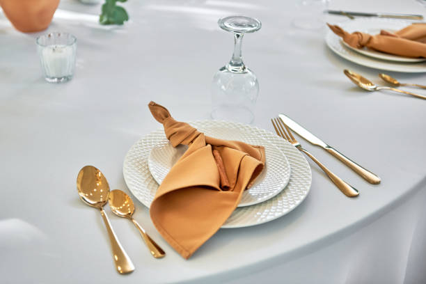 istock Table setting with sparkling wineglasses, plate with brown napkin and cutlery on table, copy space. Place set at wedding reception. Table served for wedding banquet in restaurant 1367128213