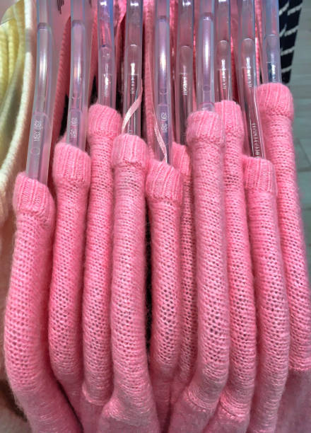 istock Clothing Store Pink Clothes on hangers 1367128445