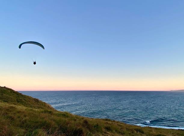 istock Paragliding Over Ocean at Sunset 1367128754