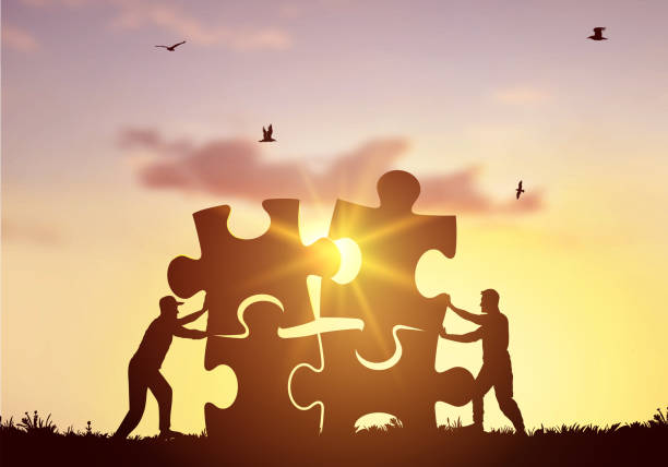 istock Vector silhouette two men pushing to connect jigsaw puzzle with sunlight and bright sky. Creative black symbol of business corporate teamwork to solutions, success and strategy concept illustration. 1367131922