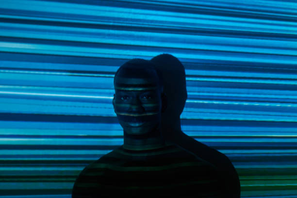 istock Serious young African man standing against wall with horizontal blue stripes 1367132509