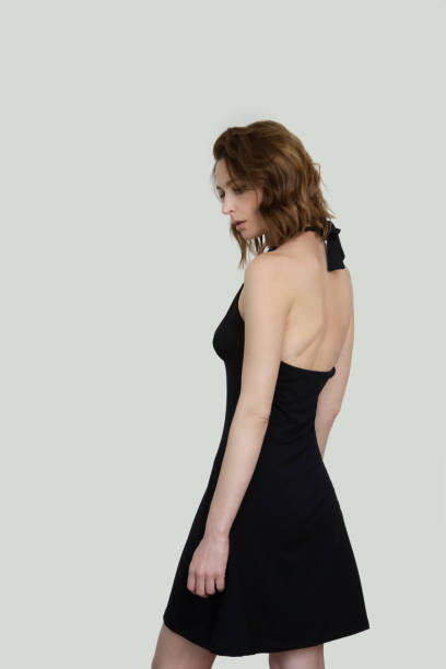 woman in black midi halter a line dress. easy summer fashion. studio shot. - halter top imagens e fotografias de stock