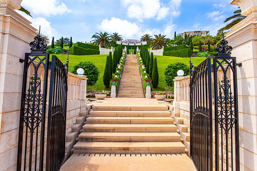 Bahai World Center. Pilgrimage center and popular tourist destination. Clear sunny day by the sea. Marble staircase and rows of cypress trees on Mount Carmel in Haifa, Israel.