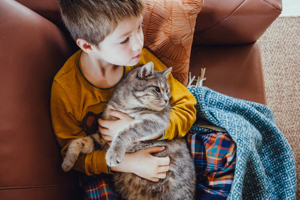 istock Kid portrait with cat at home 1367133069
