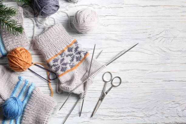 istock Flat lay of knitting and winter accessories on white background 1367135407