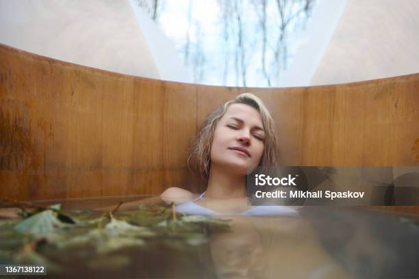 A Young Woman Takes Hot Bath In Oak Barrel In The Winter Outside Steam Barrel And Spa Center Stock Photo - Download Image Now