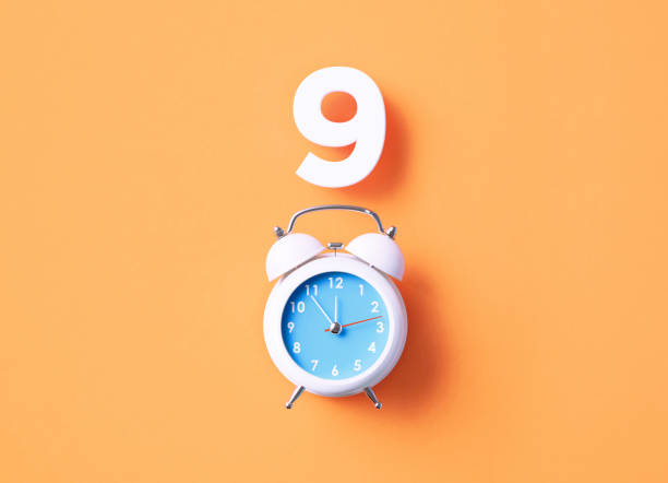 istock Number 9 Sitting Above White Alarm Clock On Orange Background 1367138270