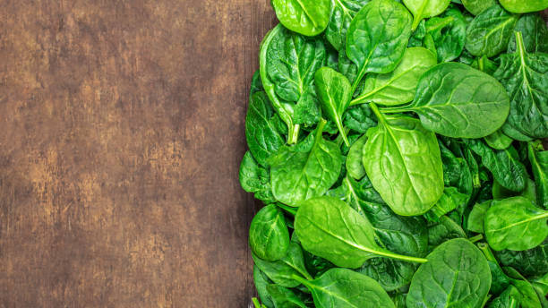 istock Spinach leaves on wooden  background. Fresh Spinach Closeup. Top view.Copyspace