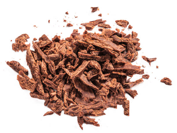 istock Grated Chocolate pieces isolated on white background. Crushed dark chocolate Top view. Flat lay