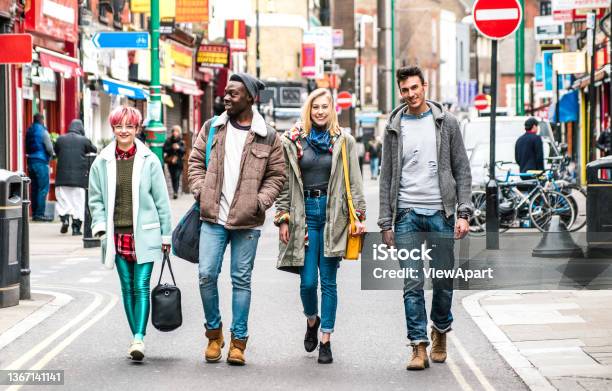 Multicultural Students Walking On Brick Lane Center At Shoreditch London Life Style Concept With Multiethnic Young Friends On Seasonal Clothes Having Fun Together Outside Bright Vivid Filter Stock Photo - Download Image Now