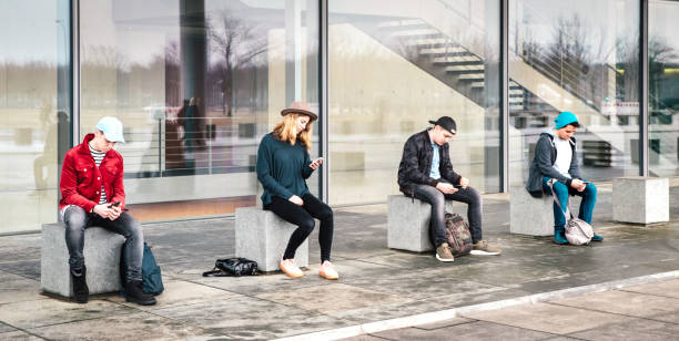 istock Teenager group using smartphone sitting at college backyard break - Young people addicted by mobile smart phones - Technology concept with always connected milenials - Bright vivid filtered image 1367141345