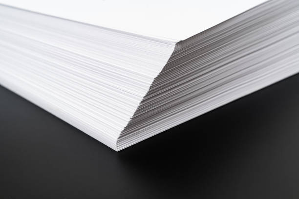 istock close-up a stack angle of sheets of white paper on a black background. 1367144069