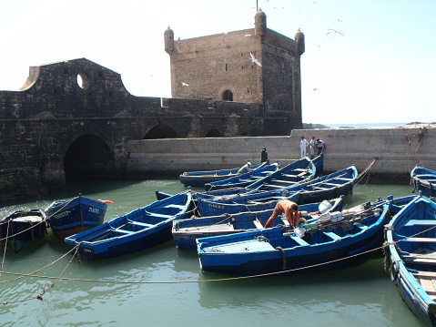 Essaouira, Morocco, August 15, 2012: Blue fishing boats in the fishing port of Essaouira, Morocco
