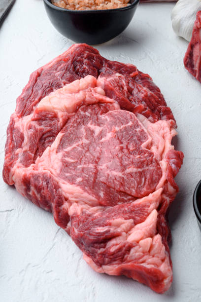 istock Raw fresh marbled meat Steak Ribeye Black Angus, on white stone  background, top view flat lay 1367144373