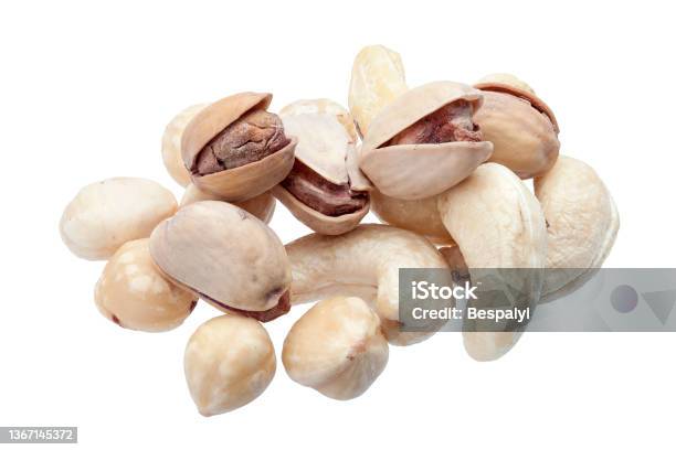 Peeled Hazelnuts And Cashew With Salted Pistachio In Shell Pile Of Deferent Nuts Closeup Of Protein Healthy Food Isolated On White Background Nobody Stock Photo - Download Image Now