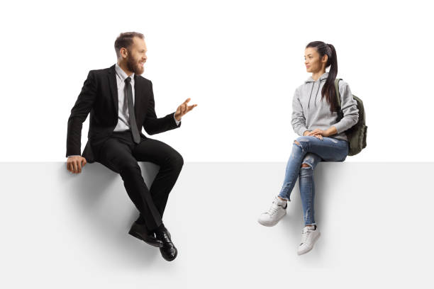 istock Businessman sitting on a panel and talking to a female student 1367145902