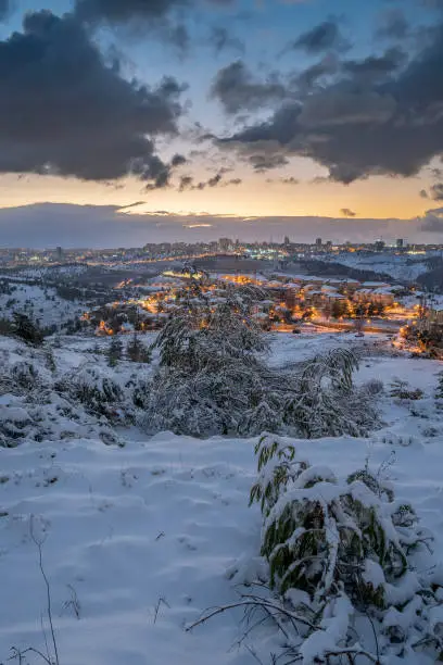 A sunrise over the snow covered Jerusalem, Israel, and the Judea mountains.