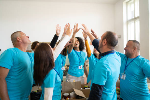 istock Volunteers with their hands raised in a circle 1367146065