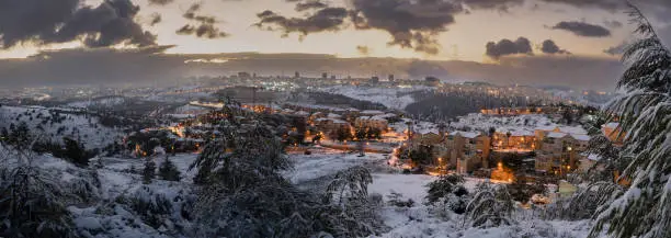 A sunrise over the snow covered Jerusalem, Israel, and the Judea mountains.