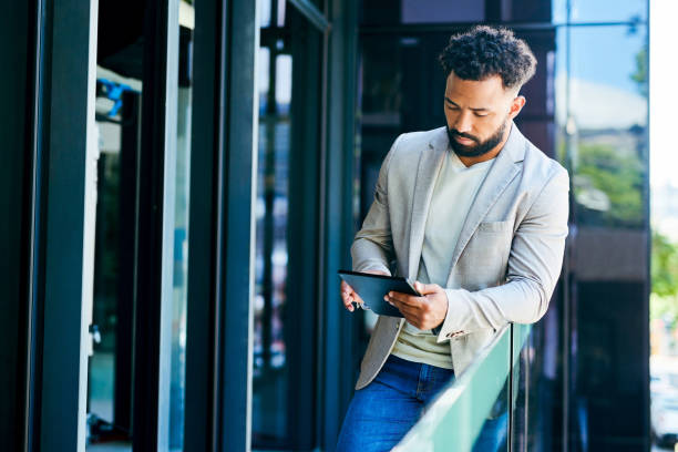 istock Shot of a young businessman using a digital tablet at work 1367150102