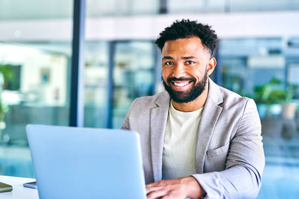 istock Shot of a young businessman using a laptop in a modern office at work 1367150115