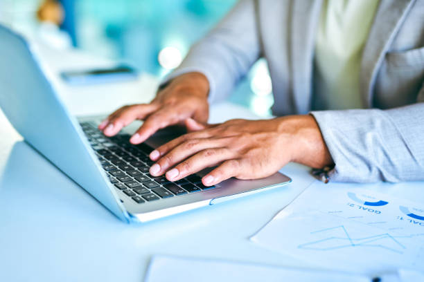 istock Shot of an unrecognizable businessman using a laptop in a modern office at work 1367150120