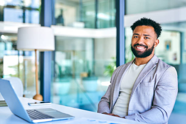 istock Shot of a young businessman using a laptop in a modern office at work 1367150129