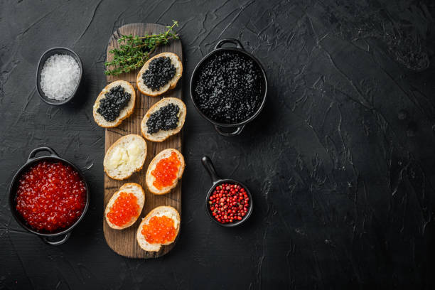 istock Sandwiches with red and black caviar    , on black background, top view flat lay  with copy space for text 1367150175
