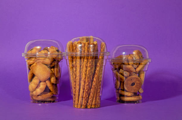 istock Bread sticks in clear plastic cup on purple background 1367151377