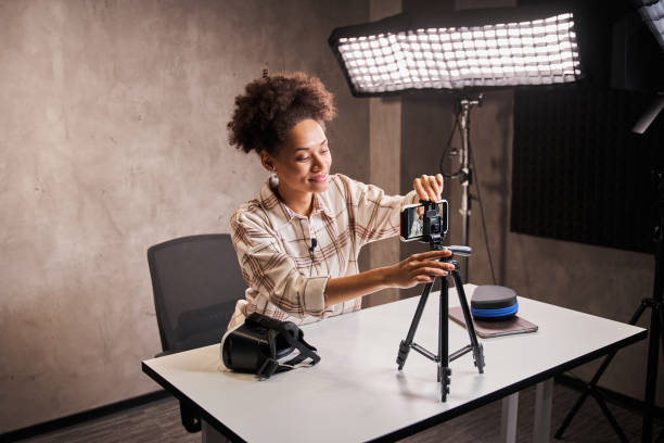 istock Multiracial woman making video for her blog about technologies 1367152452